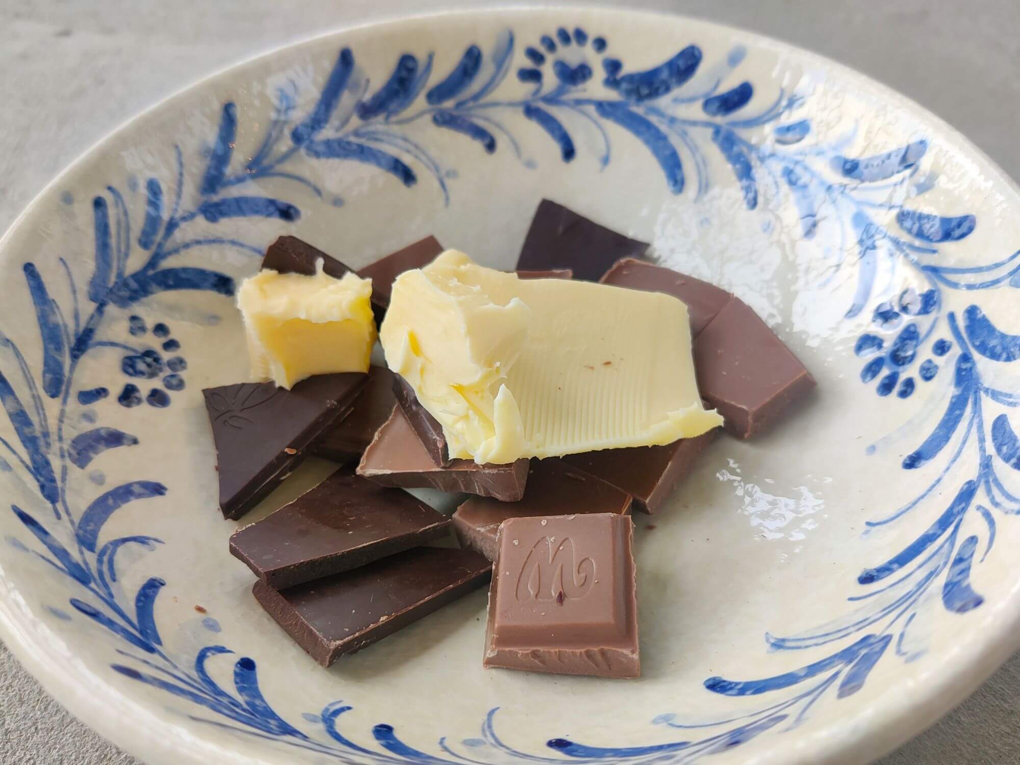 Chocolate and butter in a white blue bowl