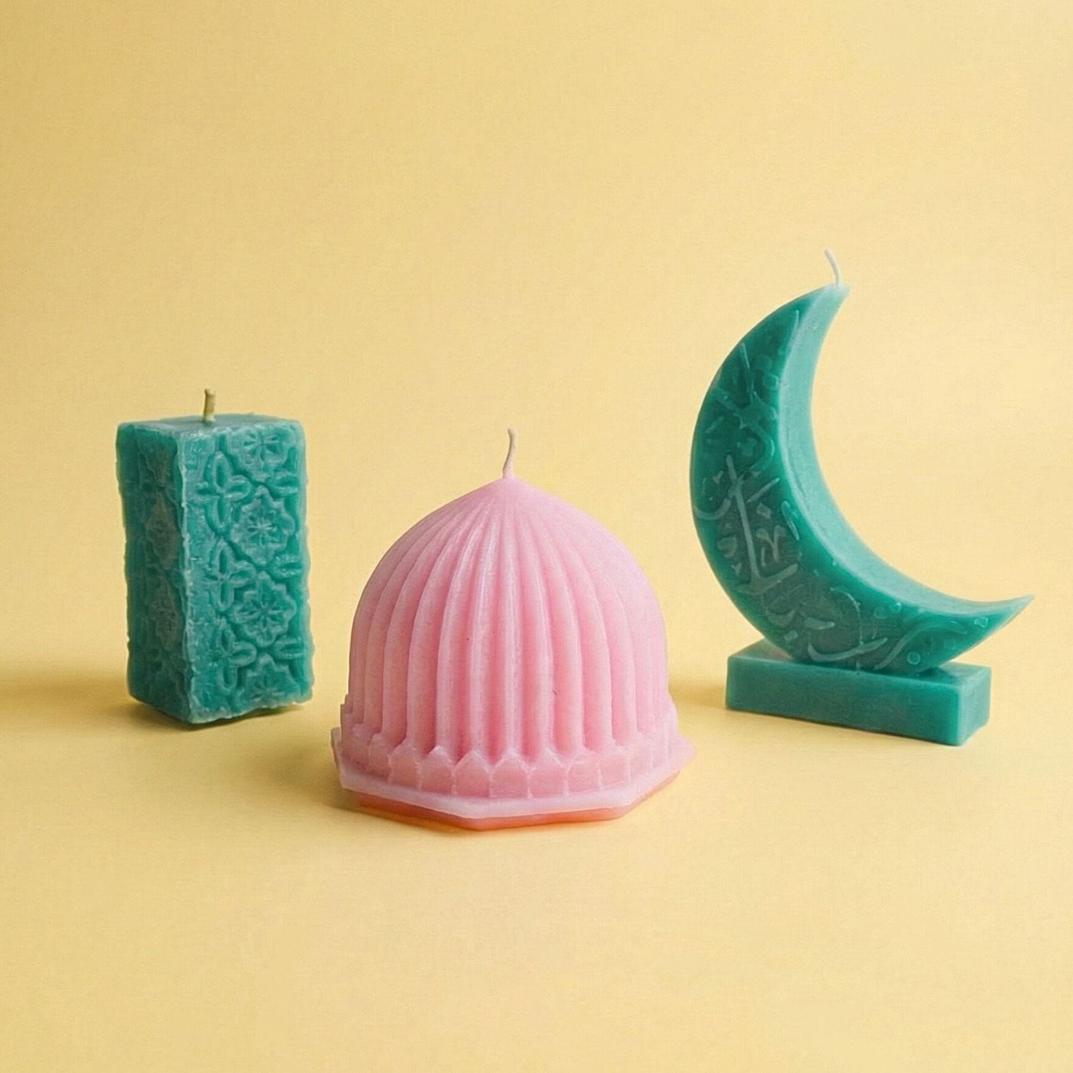 Pastel beeswax Ramadan candles in architectural shapes, including a dome, crescent moon, and patterned pillar on a soft neutral background.