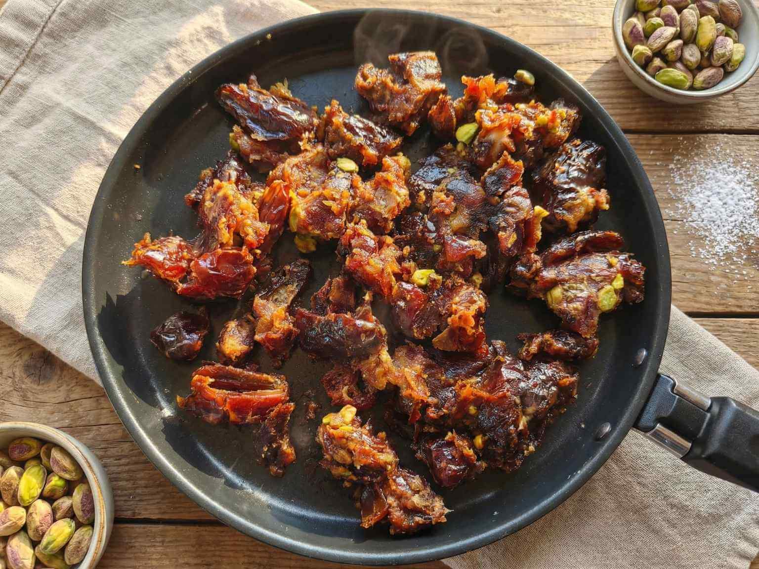 warming medjool dates and pistachios with butter in a pan