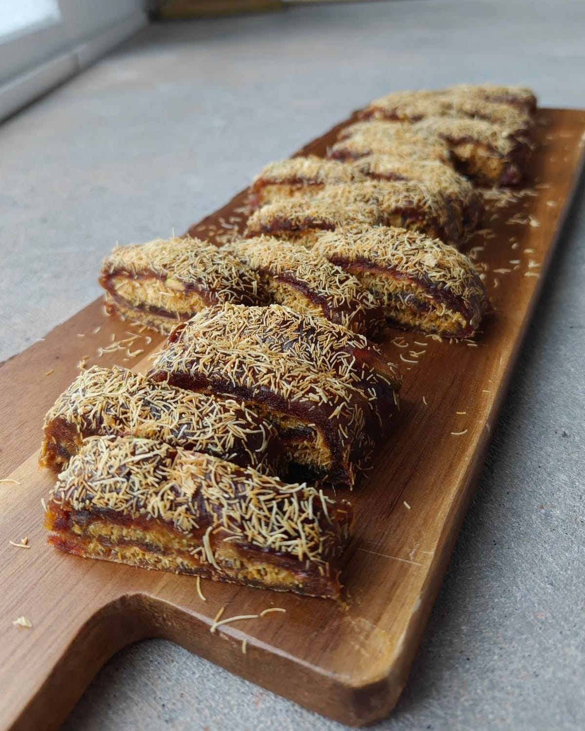 healthy no-bake date dessert with pistachio and crispy kataifi slices